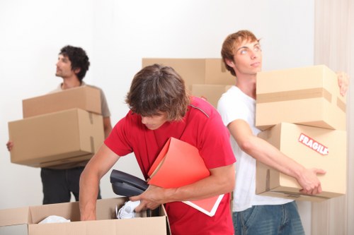 Packed boxes and a moving team preparing for a local house removal