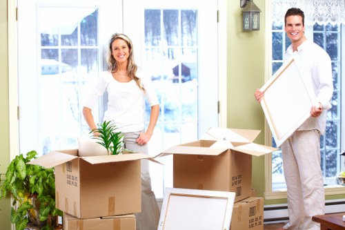 Professional movers handling household furniture in a Crystal Palace home